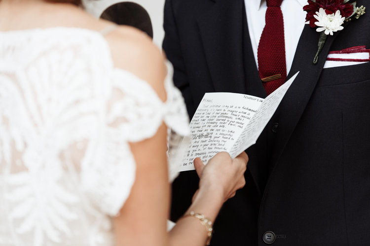 closeup of bride reading wedding vows