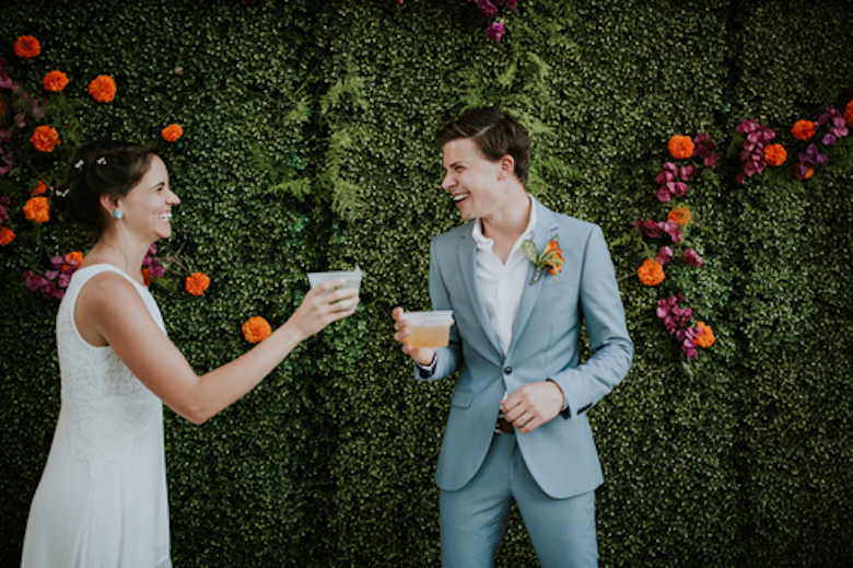 bride and groom drinking cocktails at their casual wedding