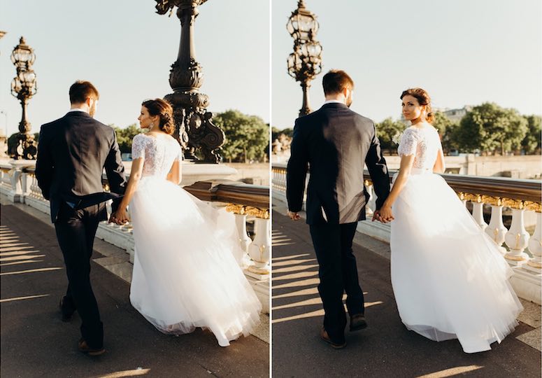 couple walking down a bridge holding hands