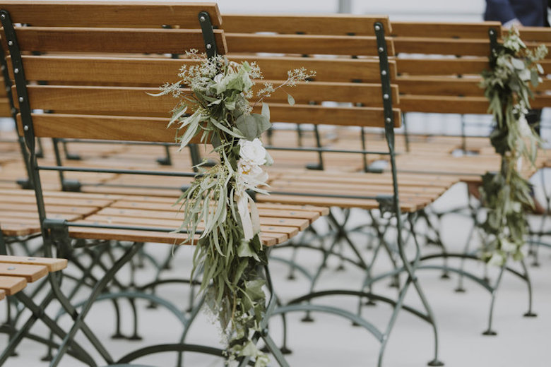 wood benches with floral details for summer wedding