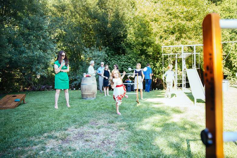 guests playing games in a backyard playground 