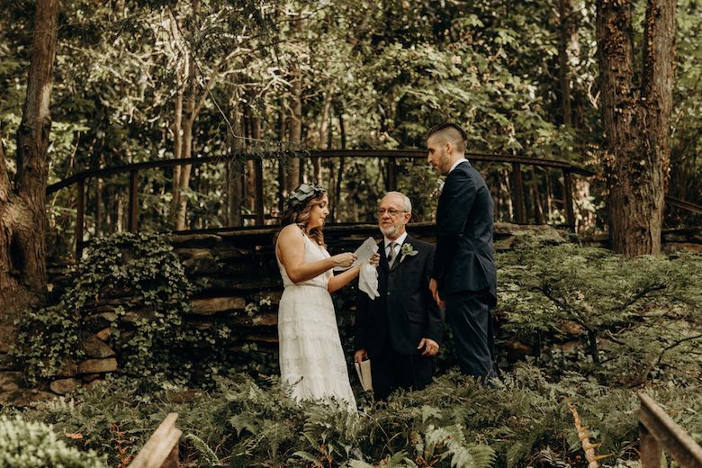 couple saying vows in forest