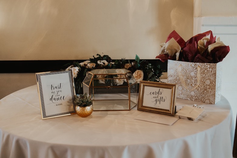 wedding gift table with a potted succulent and various decorations
