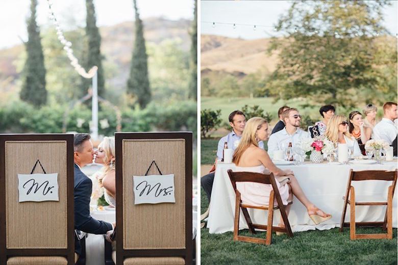 outdoor wedding reception with wedding guests listening to a wedding toast while the bride and groom share a kiss
