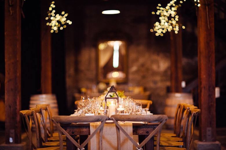 elegant wooden table setting at wedding rehearsal dinner