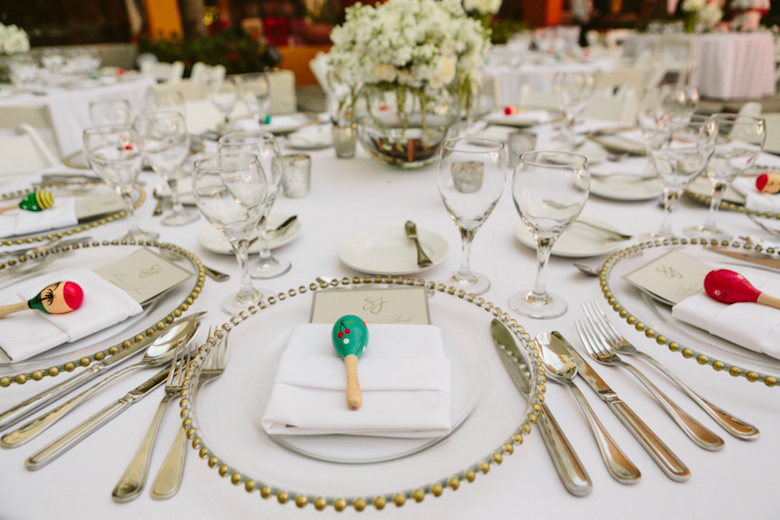 wedding rehearsal dinner table set with plating and decorations
