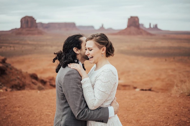 bride and groom hugging with a canyon scene as their backdrop